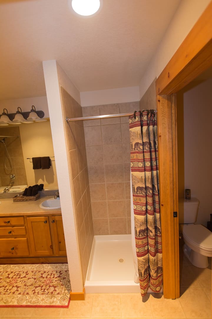 A bathroom with a shower and toilet in it