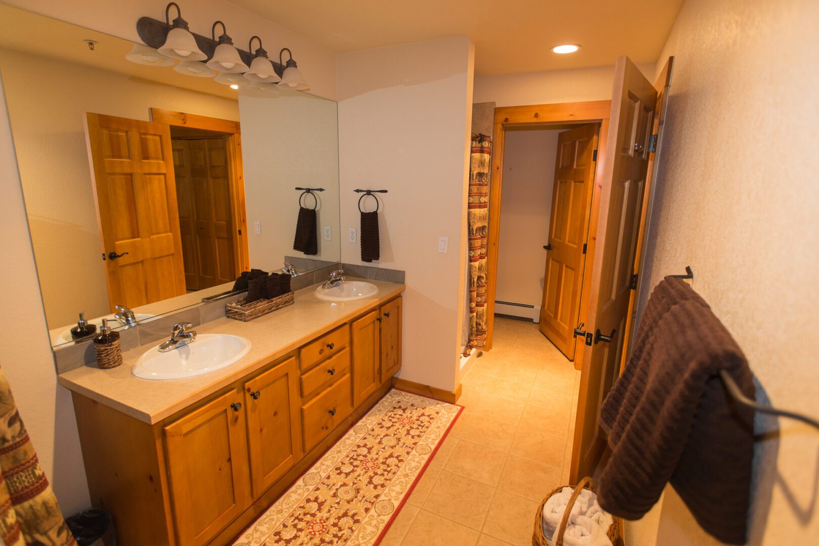 A bathroom with two sinks and a large mirror.