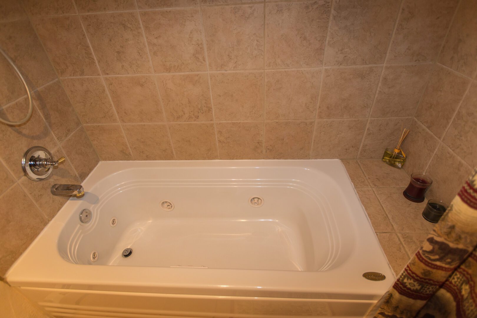 A bathtub with tile walls and floor in the background.