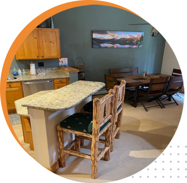 A kitchen with a table and chairs in it